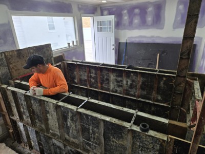 Community volunteers and contractors worked shoulder-to-shoulder — measuring, waterproofing, and laying tile. Their dedication is now visible in every polished surface of the finished space.